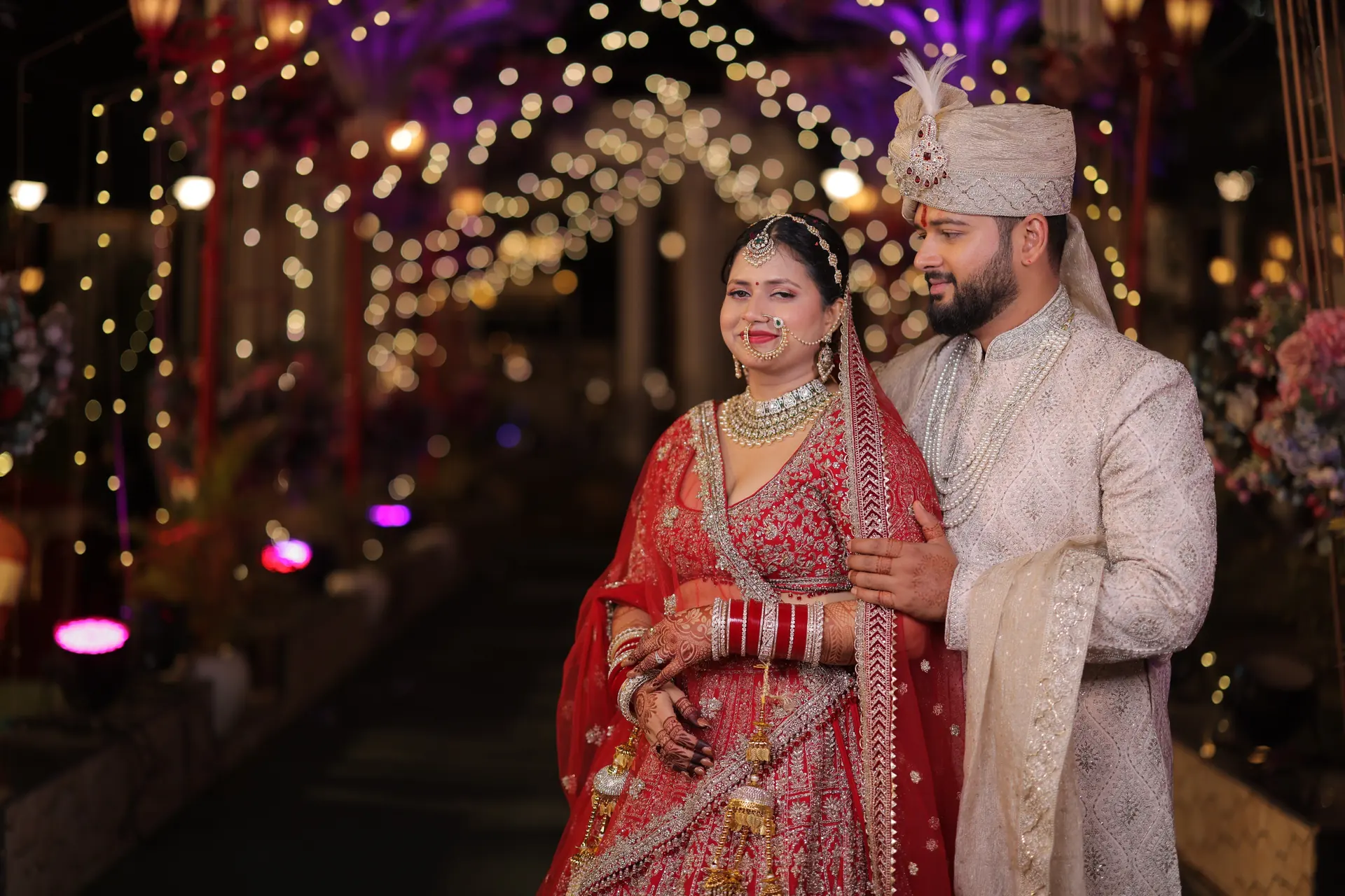Couple on lit floral walkway